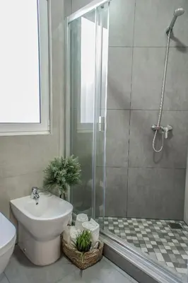 a bathroom with a shower and a toilet and a sink at Trendy Apartments in Funchal