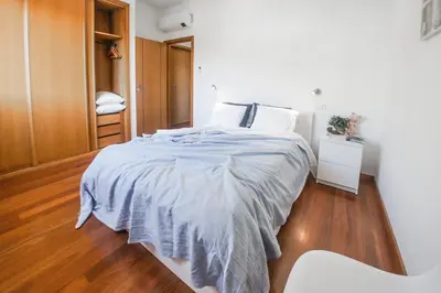 a bedroom with a bed with a blue comforter at Trendy Apartments in Funchal