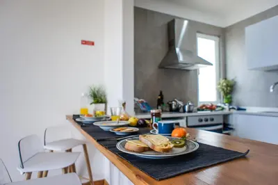 a kitchen with a table with plates of food on it at Trendy Apartments in Funchal