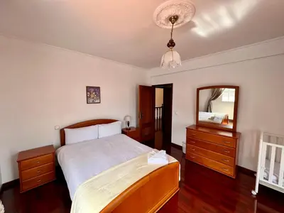 a bedroom with a bed and a large mirror at Classic Tranquil Madeiran 4-Bedroom Villa Funchal in Funchal