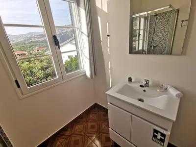 a bathroom with a sink and a window at CASA DOS AVÓS Apartments with Pool in Funchal in Funchal