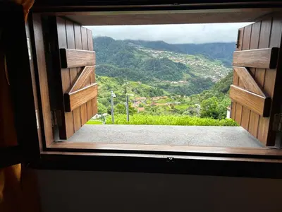 a window with a view of a mountain view at Zef's Cottage in São Vicente