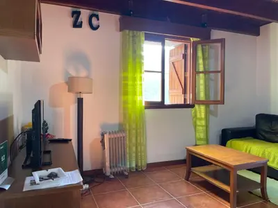 a living room with a couch and a window at Zef's Cottage in São Vicente