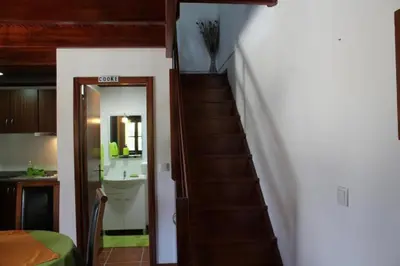 a stairway leading to a bathroom and a sink at Zef's Cottage in São Vicente