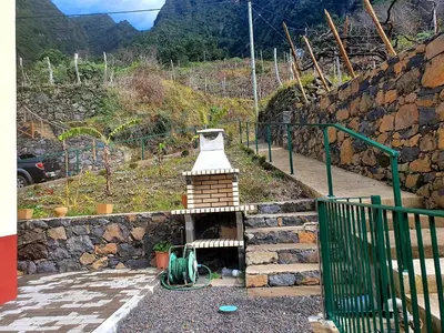 a small oven in a stone wall next to a mountain at Zef's chalet in Senhora do Rosário