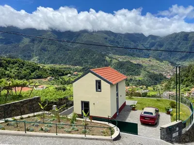a small house with a car parked in a lot at Zef's chalet in Senhora do Rosário