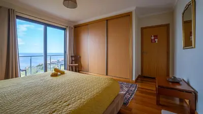 a hotel room with a bed and a large window at The Goat's Place in Gaula
