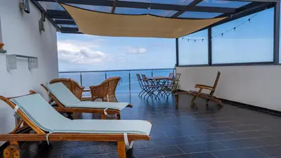 a balcony with chairs and tables on a ship at The Goat's Place in Gaula