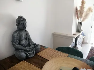 a statue of a buddha sitting on a table at Komfortables Town House in traumhafter Lage in Budens