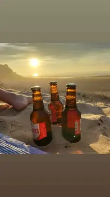 a group of beer bottles sitting on the beach at Komfortables Town House in traumhafter Lage in Budens