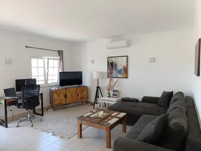 a living room with a couch and a table at Komfortables Town House in traumhafter Lage in Budens