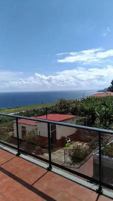 a view of the ocean from the balcony of a house at Villas Madalena Chalets vista mar cWiFi in Santa Cruz