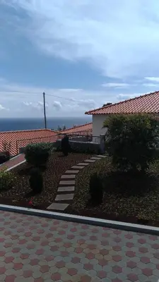 a house with a walkway in front of a building at Villas Madalena Chalets vista mar cWiFi in Santa Cruz