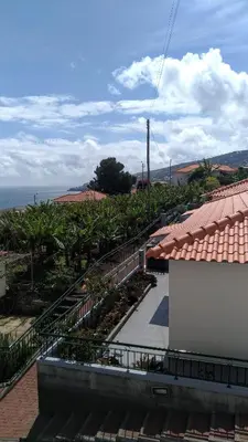 a balcony of a building with stairs and plants at Villas Madalena Chalets vista mar cWiFi in Santa Cruz