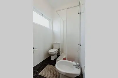 a white bathroom with a toilet and a sink at City View Gardens in Funchal