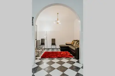 a living room with a couch and a red rug at City View Gardens in Funchal