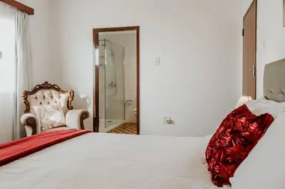 a bedroom with a bed with a red blanket on it at City View Gardens in Funchal