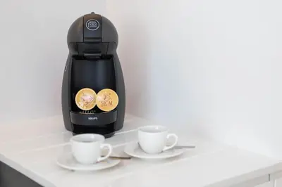 a coffee maker and two cups on a counter at Golden Sea Horizon in Funchal