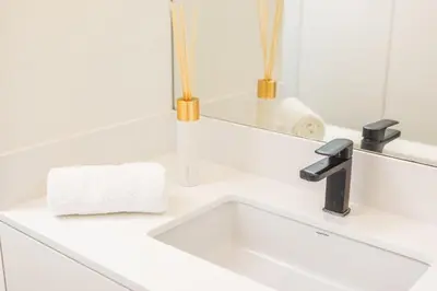 a white sink in a bathroom with a mirror at Golden Sea Horizon in Funchal