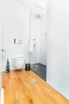 a bathroom with a toilet and a glass shower at Golden Sea Horizon in Funchal