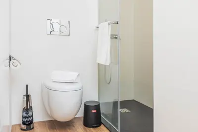 a bathroom with a toilet and a glass shower at Golden Sea Horizon in Funchal