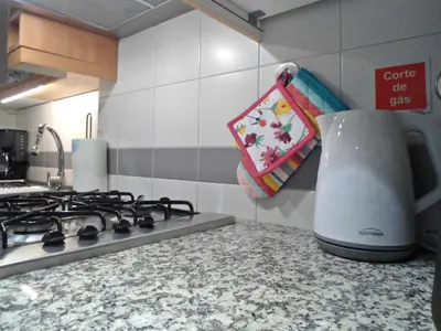 a kitchen counter with a blender on a stove at Garden's Apartment in Funchal