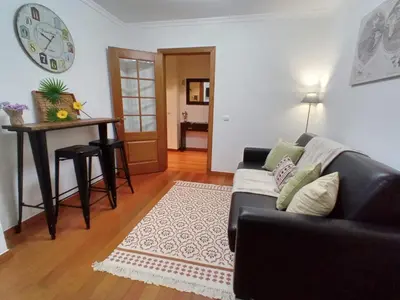 a living room with a couch and a table at Garden's Apartment in Funchal