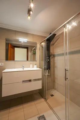 a bathroom with a sink and a shower at Ocean Breeze in Caniço