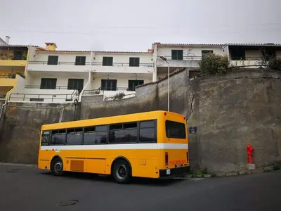 a yellow bus parked in front of a building at Casa Alegria in Funchal