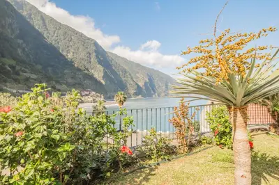a garden with a view of the water and mountains at Lajesol in Seixal
