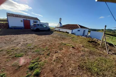 a car parked on a hill in front of a house at casa Eira Alta in Santa Bárbara