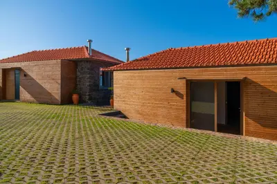 a house with a brick yard next to a building at Villa Fauna - Nature & Tranquility - Heated pool optional in Prazeres