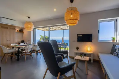 a living room with a table and chairs and a couch at Villa Fauna - Nature & Tranquility - Heated pool optional in Prazeres