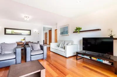 a living room with a large flat screen tv at Baia da Luz - Great Light apartment in Luz