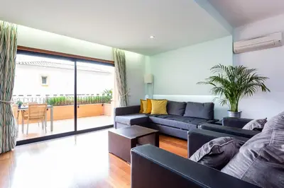 a living room with a couch and a table at Baia da Luz - Great Light apartment in Luz