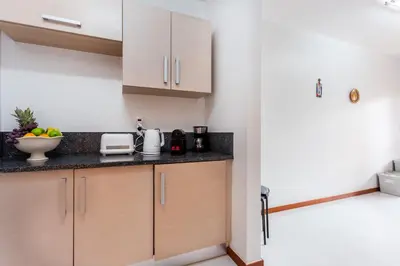 a kitchen with wooden cabinets and a counter top at Baia da Luz - Great Light apartment in Luz