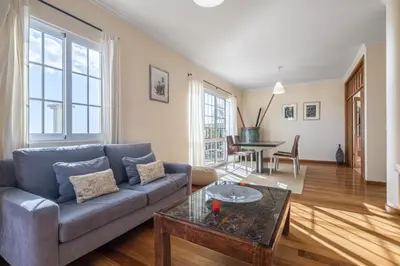 a living room with a couch and a table at Casa das Neves - By Wehost in Funchal