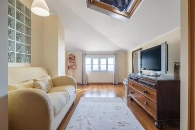 a living room with a couch and a flat screen tv at Casa das Neves - By Wehost in Funchal