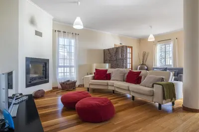 a living room with a couch and a tv at Casa das Neves - By Wehost in Funchal