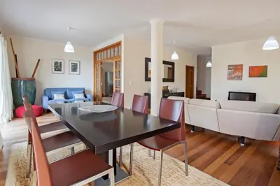 a dining room and living room with a table and chairs at Casa das Neves - By Wehost in Funchal