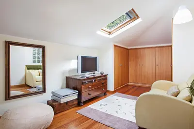 a living room with a tv and a couch and a mirror at Casa das Neves - By Wehost in Funchal