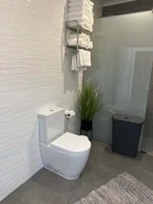 a white toilet in a bathroom with towels at Casa Bela Vista in Venda do Atalhinho
