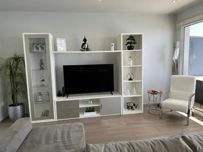 a living room with a large white entertainment center at Casa Bela Vista in Venda do Atalhinho