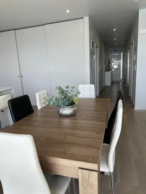 a dining room with a wooden table and white chairs at Casa Bela Vista in Venda do Atalhinho
