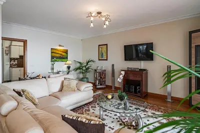 a living room with a couch and a tv at OurMadeira - Moradia da Falésia in Câmara de Lobos