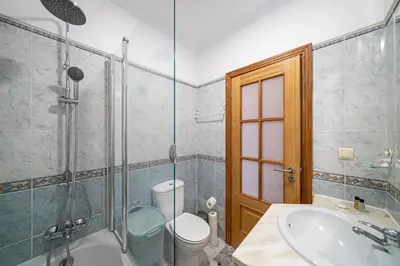 a bathroom with a shower and a sink and a toilet at OurMadeira - Moradia da Falésia in Câmara de Lobos