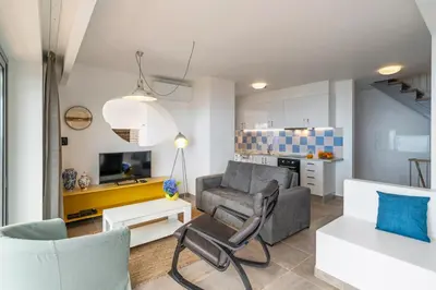 a living room with a couch and a table at OurMadeira - Villa do Mar IV in Calheta