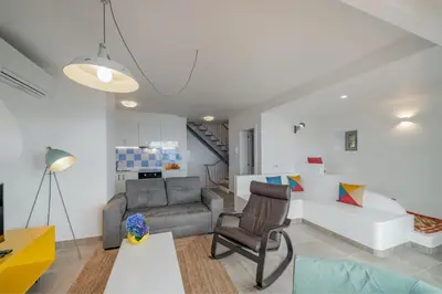 a living room with a couch and a chair at OurMadeira - Villa do Mar IV in Calheta
