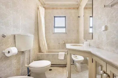 a bathroom with a toilet and a sink and a tub at Casa da Ermida in Budens