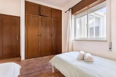 a bedroom with a bed with two towels on it at Casa da Ermida in Budens